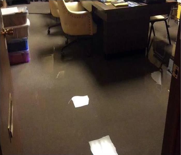 Carpet in an office building is saturated under water.