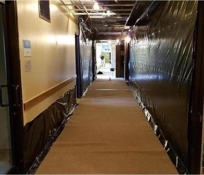 The walls in a hallway have been repaired after a mold infestation.